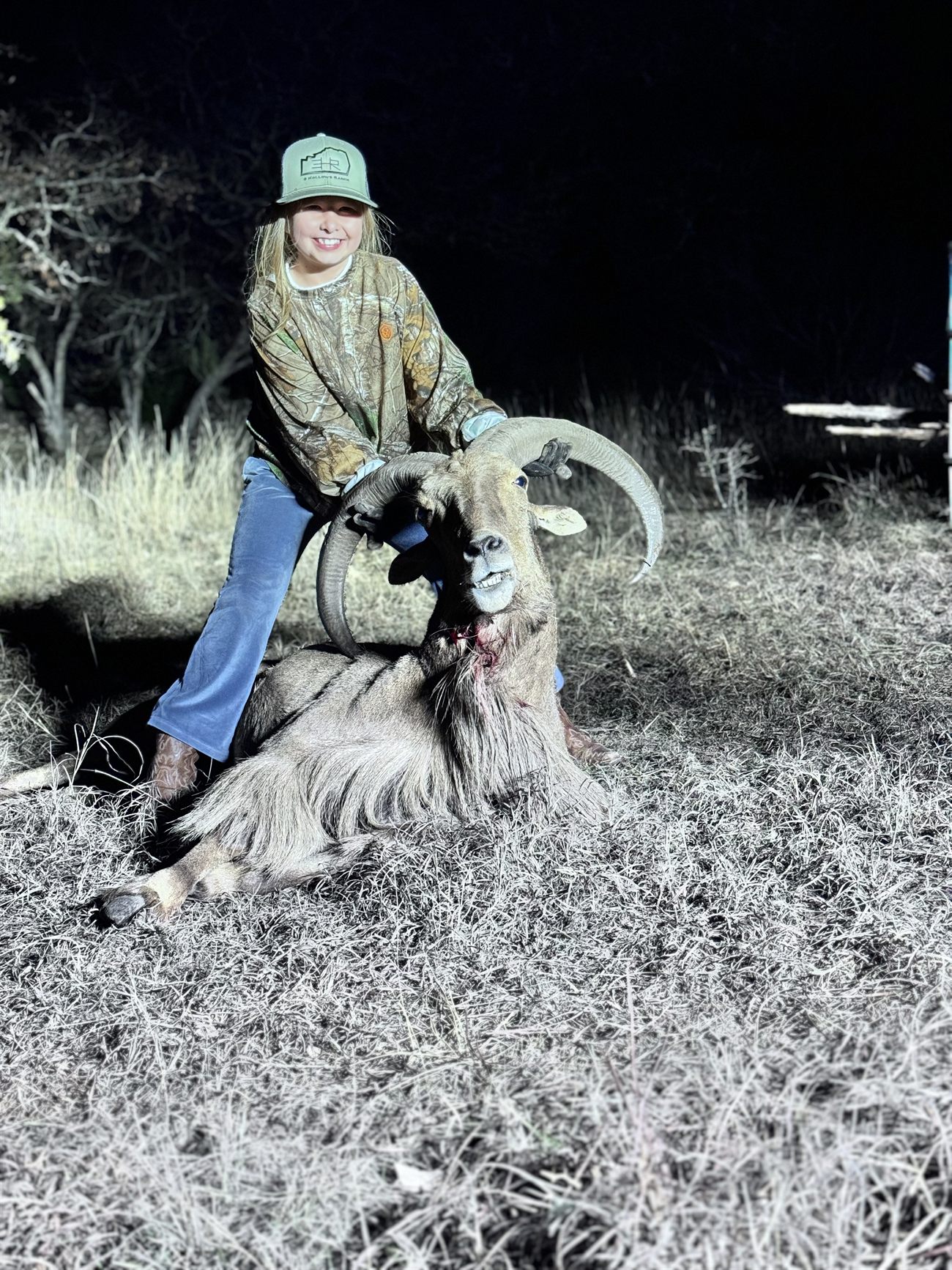 A young hunter with an aoudad ram